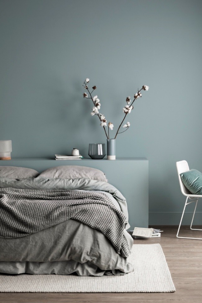 Soft artisan-finish blue bedroom wall with minimalist decor, showcasing DIY Creativity and 2025 Paint Trends