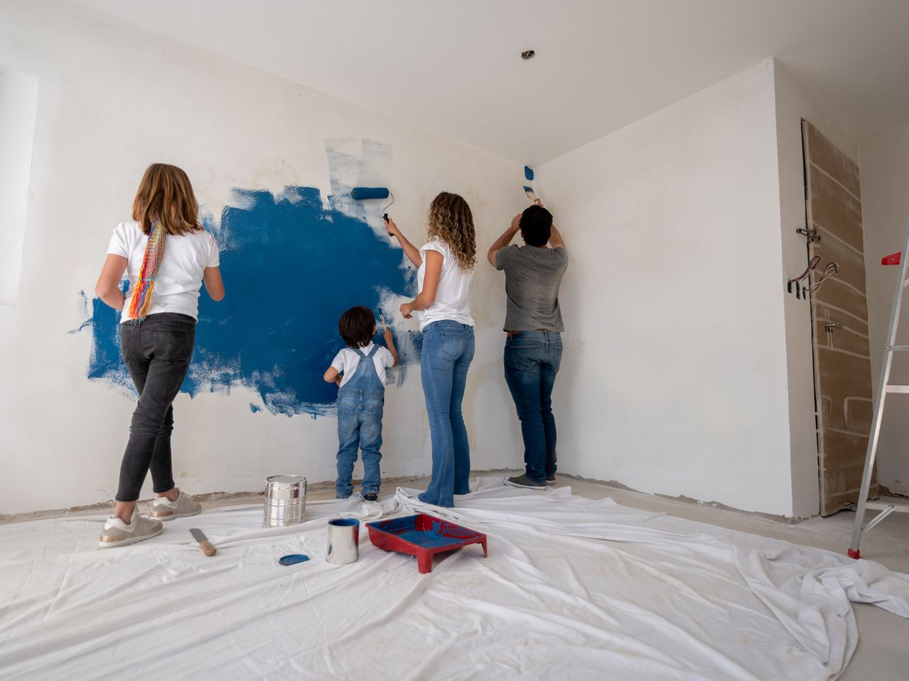 Family enjoying a DIY home painting project together, celebrating creativity and home improvement