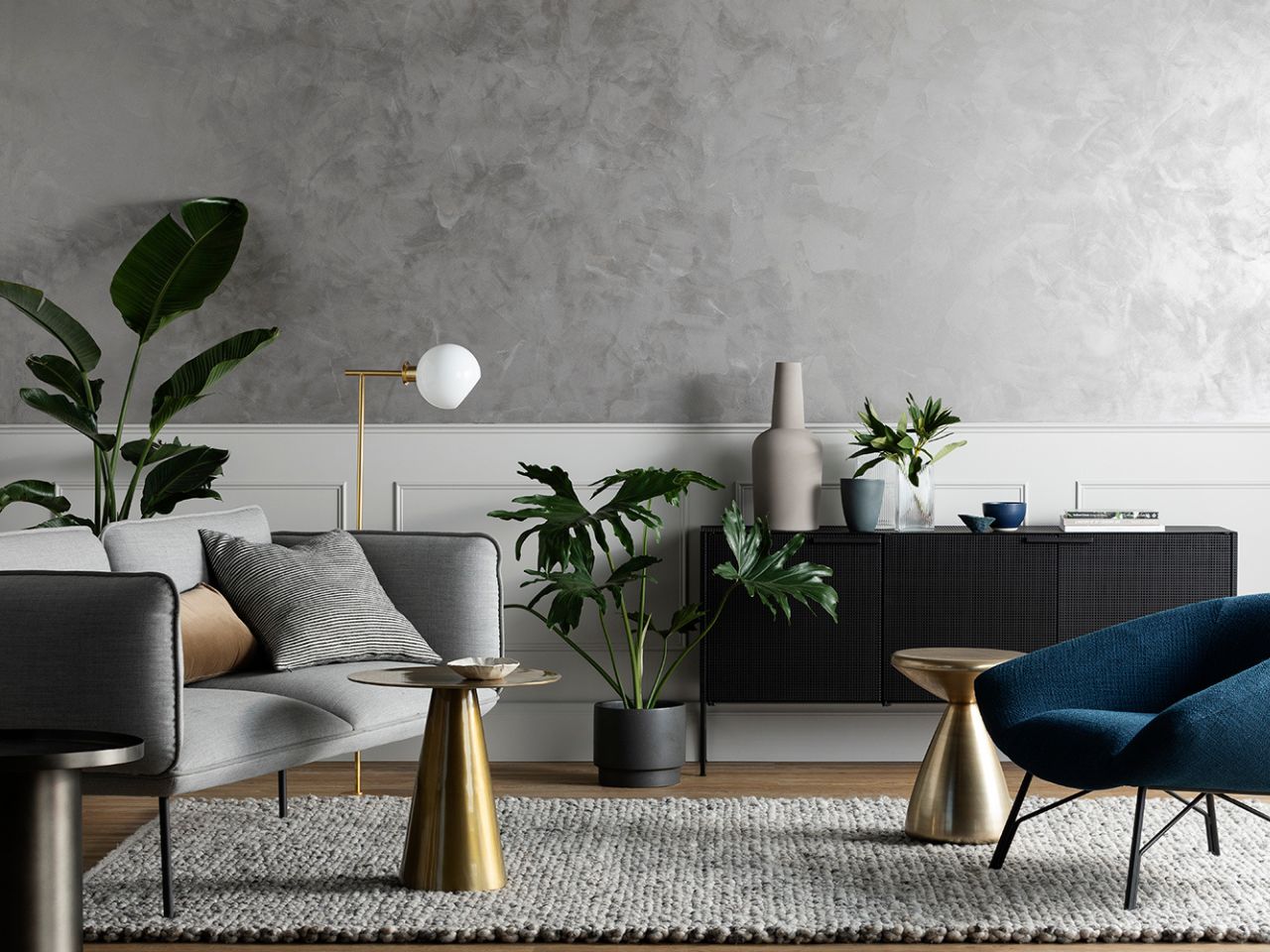Elegant living room with grey artisan-finish feature wall, showcasing DIY painting and home improvement trends