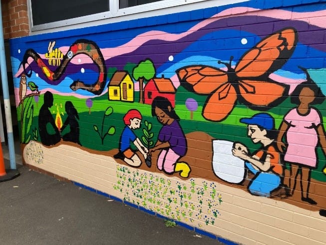 Detail of the Bexley Public School mural showing children planting as part of the “Our Living Country” artwork