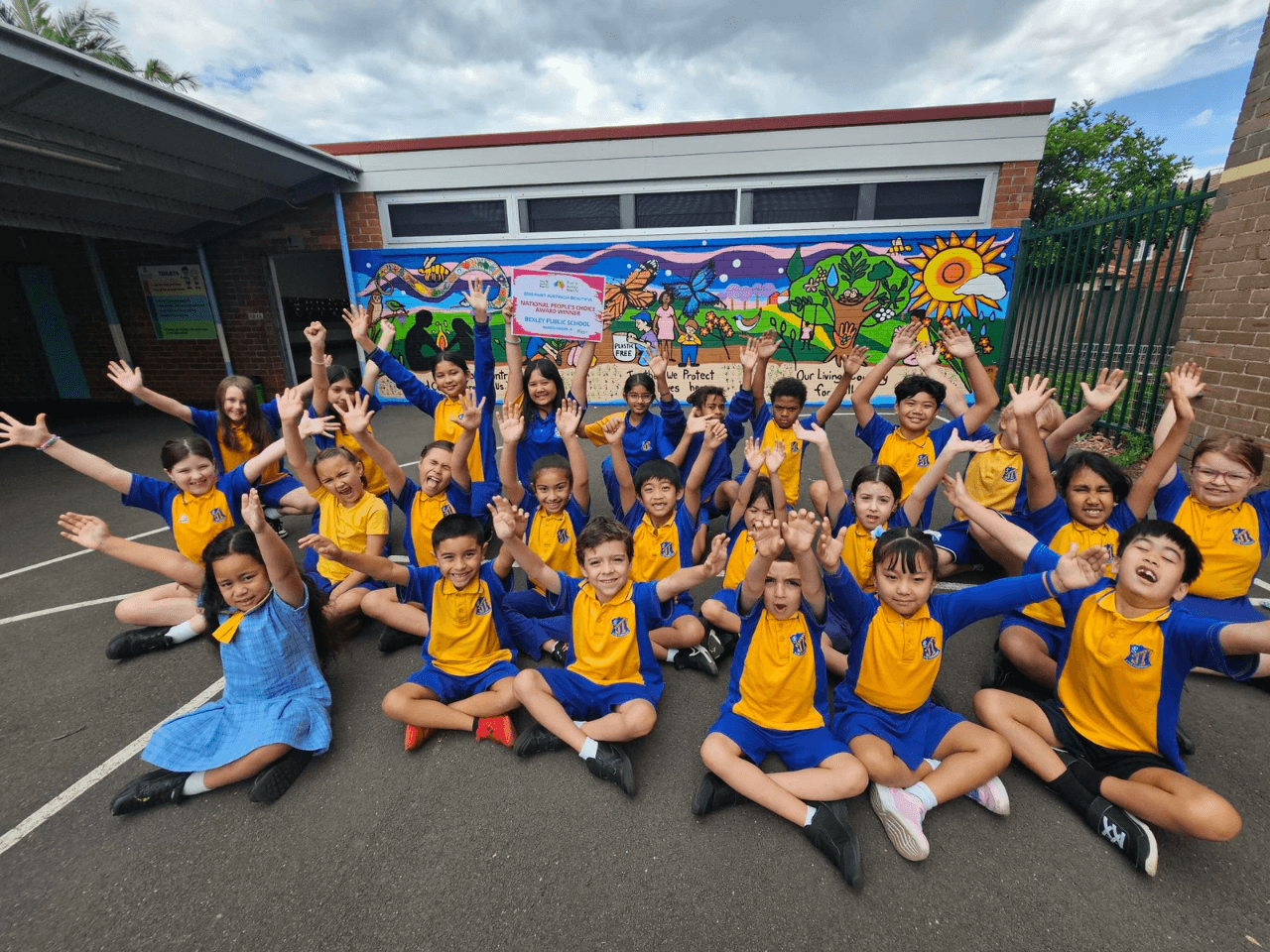Students celebrating in front of the Bexley Public School mural after the Paint Australia Beautiful win