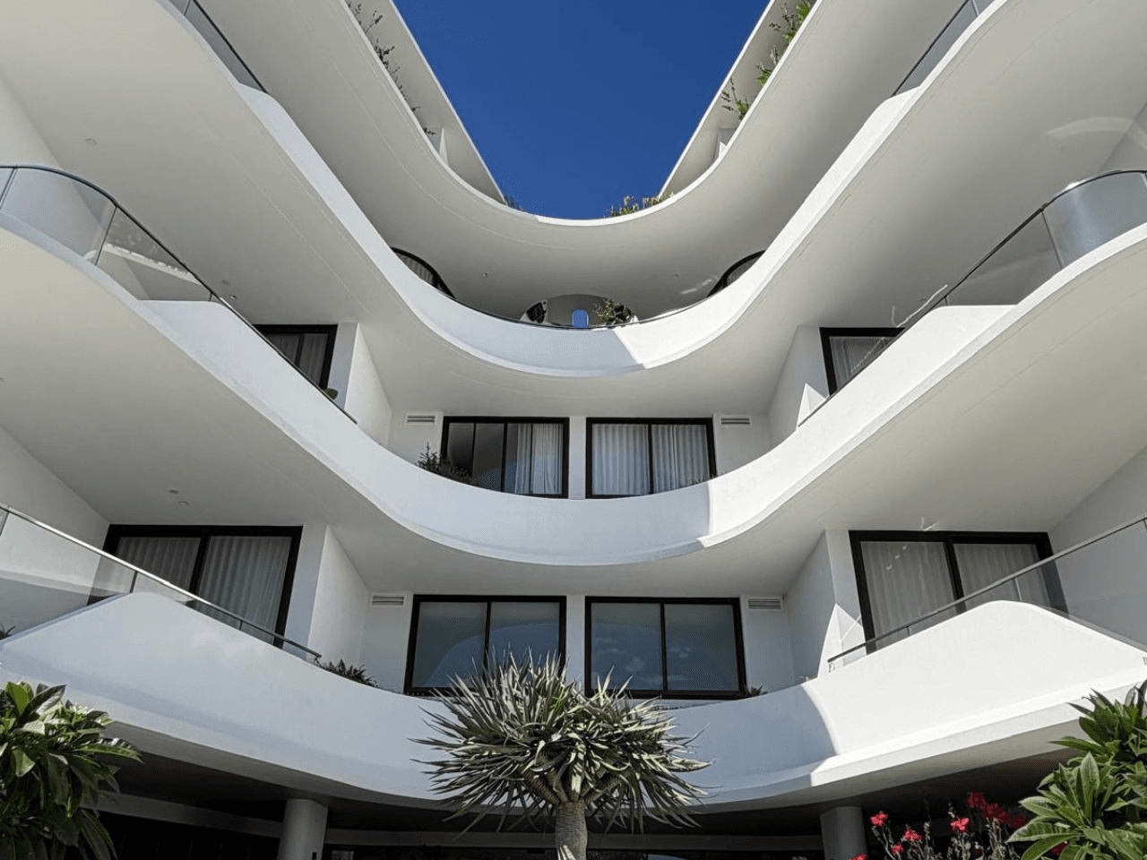 Internal courtyard view highlighting the curved rendered balconies and flowing architectural design of Solstice Cronulla