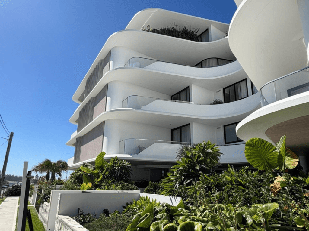 Solstice Cronulla luxury coastal apartment development featuring curved rendered balconies and contemporary architecture